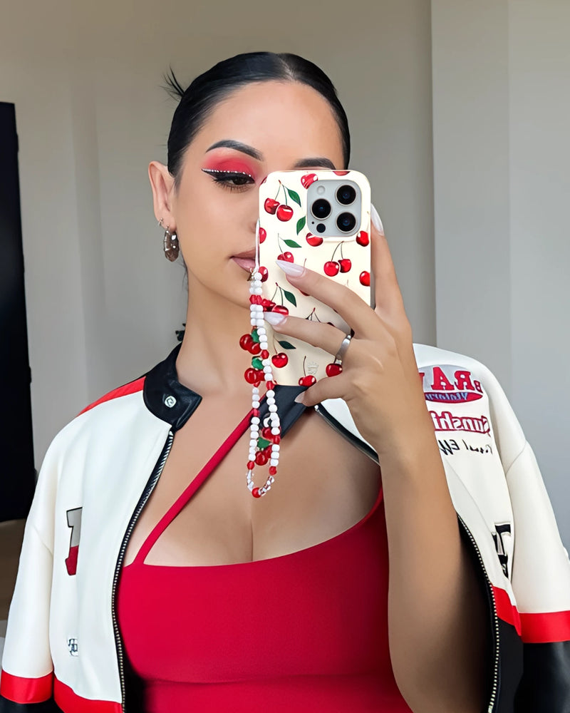 Woman in red top taking selfie with cherry fruit phone case featuring cute red berry pattern